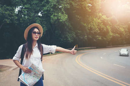 happy female tourist to Waving bus travel during vacation.Travel concept.の写真素材