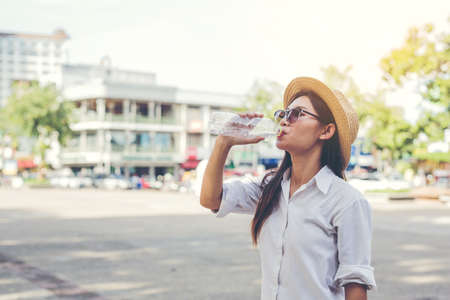 Asian female tourists drink water.の写真素材
