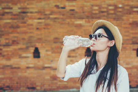 Asian female tourists drink water.の写真素材
