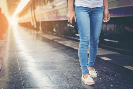 Happy woman tourists in the train station .Travel concept.の写真素材