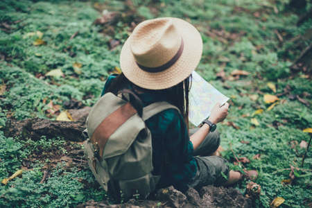 Happy female tourist  to travel on atlas in hiking during vacation.Travel concept.