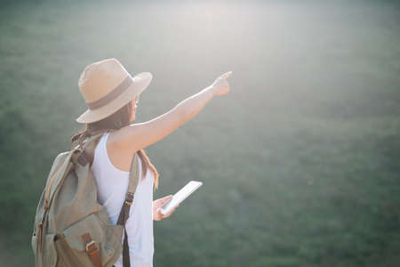 Happy woman tourist  to travel on atlas in hiking during vacation.Travel concept.の写真素材