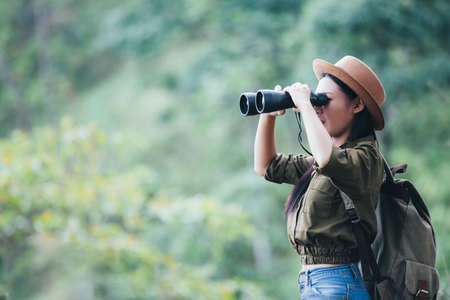 Hiking woman with binoculars, Hiking concept.の写真素材