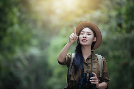 Hiking woman with binoculars, Hiking concept.の写真素材