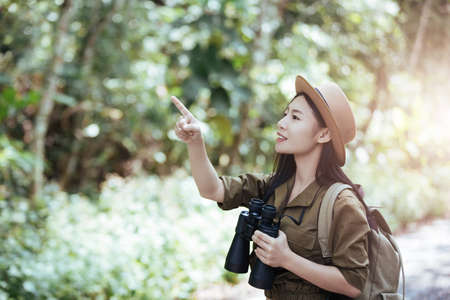 Hiking woman with binoculars, Hiking concept.の写真素材