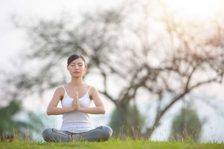 Lady practicing yoga in park outdoor. Meditation.の写真素材