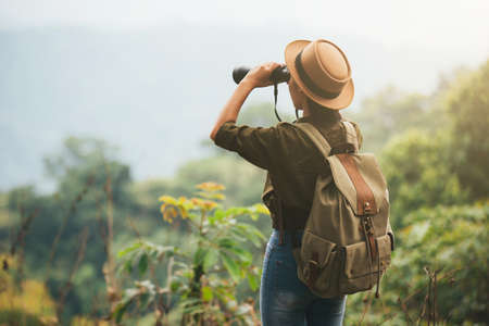Hiking young woman with binoculars, Hiking concept. Hiking conceptの写真素材