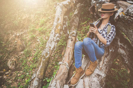 Girl traveling with a backpack on the forest, Hiking concept.