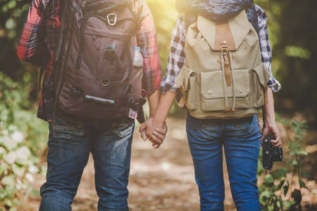 Lovers young hiking in the forest, Travel relax, Holiday and vacation, Love and relations, Travel hiking, Hiking concept.の写真素材