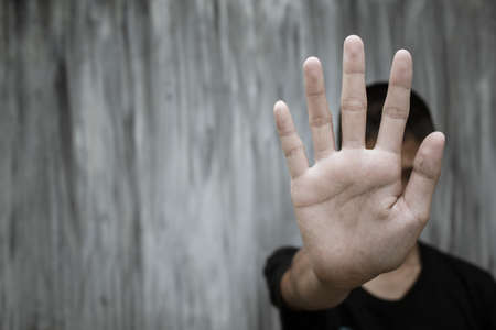 Stop, Child standing with outstretched hand showing stop, Violence concept.の写真素材