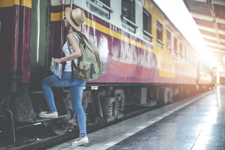 Traveler girl with a backpack traveling to the train station. Travel ideas