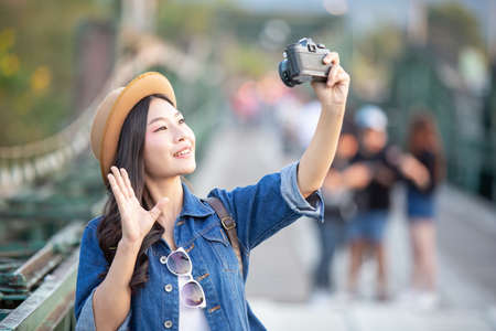 Female tourists who are taking photos of the atmosphere and smile happily.