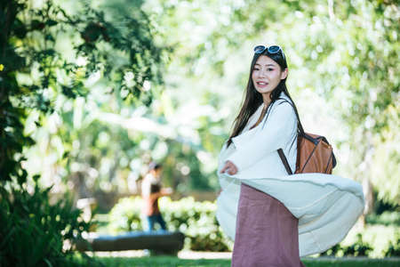 Female tourists spread their arms and held their wings, smiling happily.の写真素材