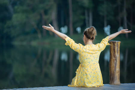 Female tourists spread their arms and held their wings, smiling happily.の写真素材