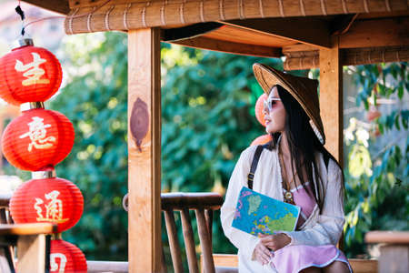 Female tourists on hand have a happy travel map.の写真素材