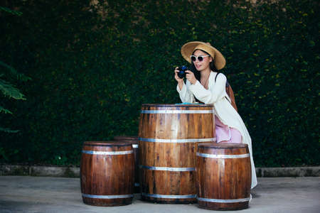 Female tourists who are taking photos of the atmosphere and smile happily.の写真素材