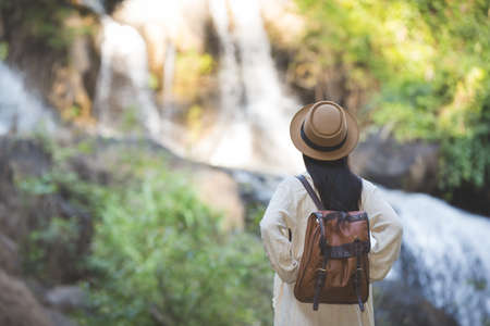 Female tourists spread their arms and held their wings, smiling happily.の写真素材