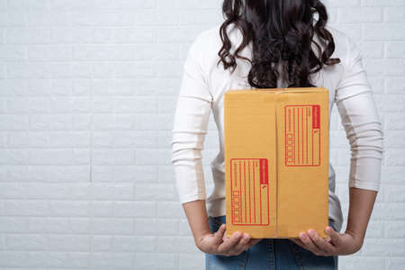 Woman holding a brown post box Made gestures with sign language.の写真素材