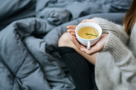 Sipping herbal tea on a cold dayの写真素材