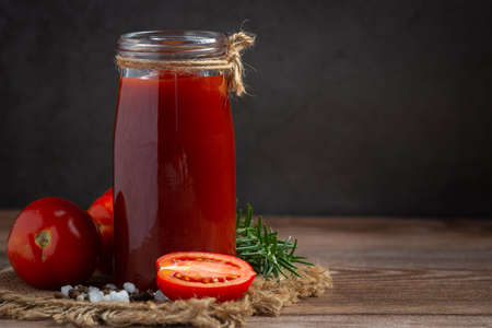 ketchup or tomato sauce with fresh tomatoの写真素材