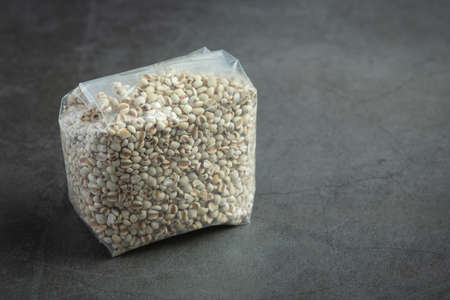 Heap of millet seeds on dark backgroundの写真素材