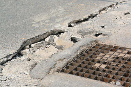 Cracked and crumbling concrete road