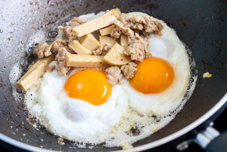 Fried eggs and pork chopsの写真素材