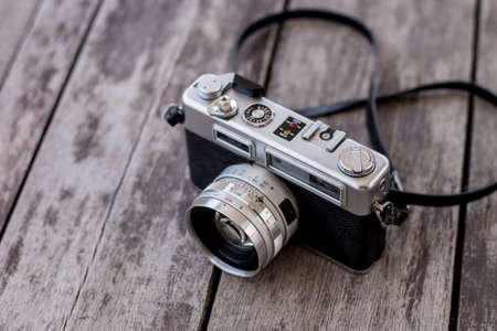 Old camera on wooden background