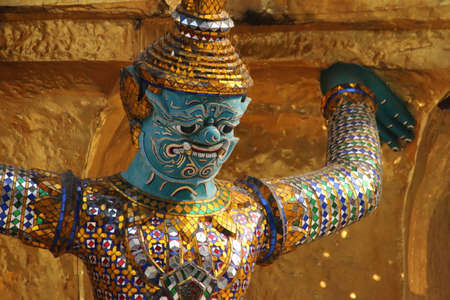 molded demon figure on the outer walls of the Temple of the Emerald Buddha, or Wat Phra Gaeo, Bangkok, Thailandの写真素材