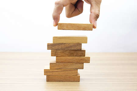 Hand choose wooden cube stacked without graphics for Business design concept and activity  for child...