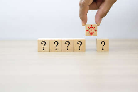 Wooden cube shape with Business Graphic icons.