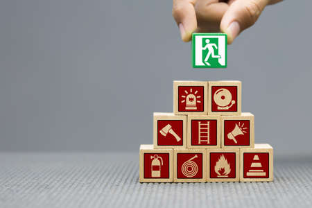 Wooded blocks Stacking with fire escape icon for safety concept.