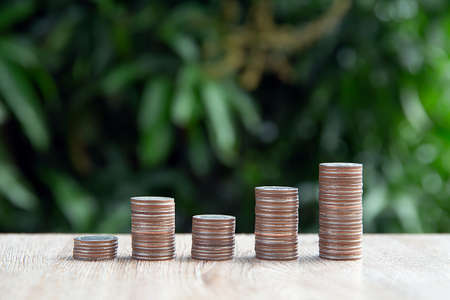 Many coins are stacked in a graph on the table for financial planning ideas and business growth