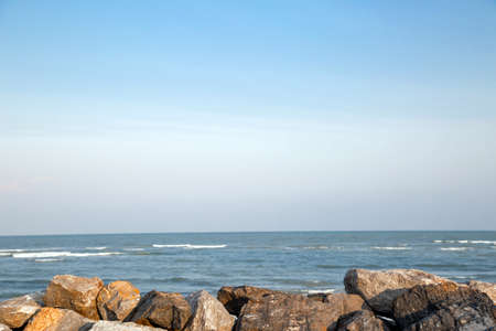 The rocky beach with the sea and blue sky.の写真素材
