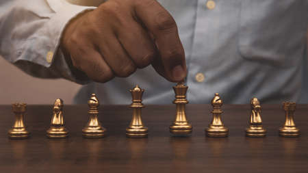 Close-up hand choose chess on chess board Concept of business strategic plan and professional teamwork and management.の写真素材