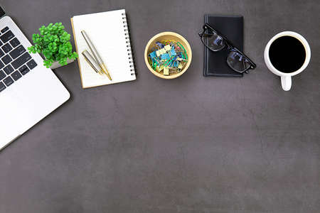 Top view desk,Modern office desk Workspace with laptop computer, coffee cup, glasses,notebook and...