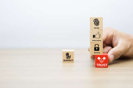 Close-up hand choose trust icon on wooden block for business à¸¢lanning and administration concept.の写真素材
