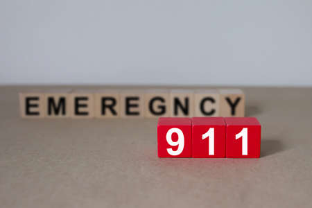 911 on wooded blocks stacked with fire and emergency icon for safety concept.の写真素材