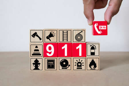 911 on wooded blocks stacked with fire and emergency icon for safety concept.の写真素材