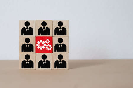 Cog and people icon on cube wooden toy blocks concepts of idea human resources for business...