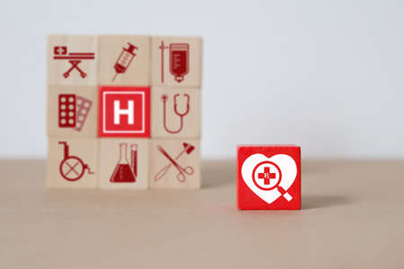 Medical and Health icons on wooden block planning for health care concept.の写真素材