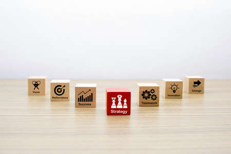 Wooden cube shape with Business icons for planning, strategy and success concept.の写真素材