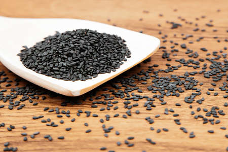 Black sesame seeds in a wooden spoon For healthy food and diet concepts.の写真素材