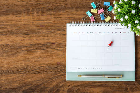 The top view blank calendar on desk office for copy space composition