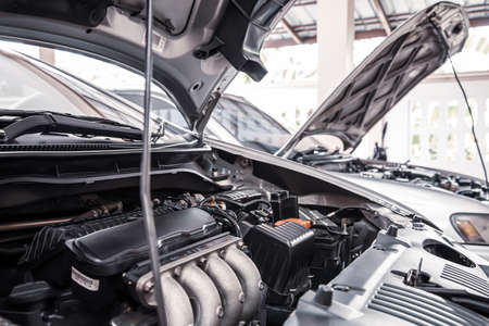 Close-up of a car engine parked in auto car garage for fixed.の写真素材