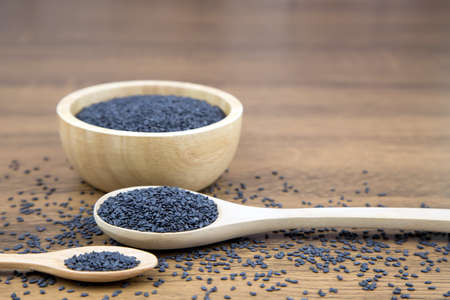 Black sesame seeds in a wooden spoon For healthy food and diet concepts.の写真素材