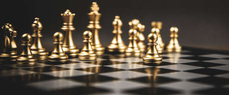 The golden chess standing in front of team. Concepts of leadership and business strategy and risk management.の写真素材