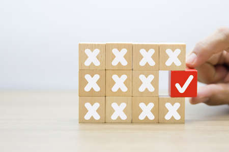 Wooden toy blocks stacked with arrow icon pointing to opposite directions for way of business change.の写真素材