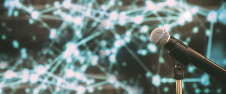 Public speaking backgrounds, Close-up the microphone on stand for speaker speech presentation stage performance with technology blur bokeh light background.の写真素材
