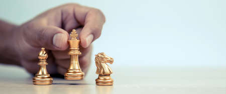 Close-up hand chooses king chess standing with a team on chess concepts of business team and...